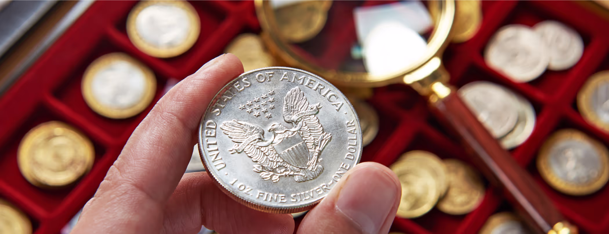 hand holding a silver coin